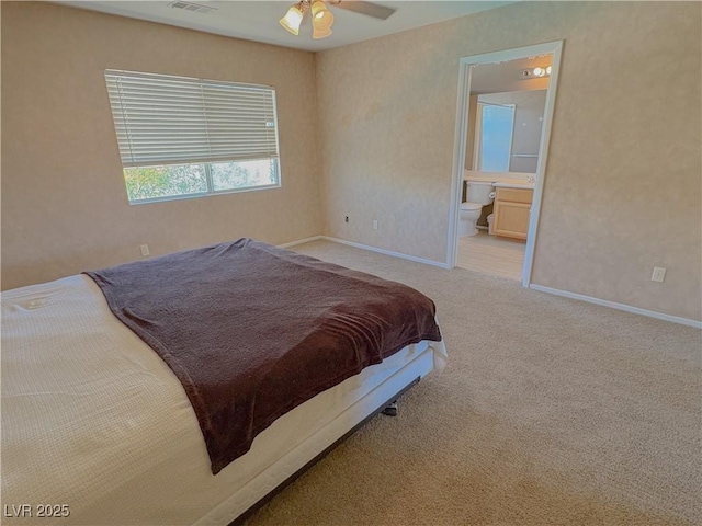 1564 Silver Knoll Ave, Las Vegas, NV 89123 - carpeted bedroom featuring ensuite bath, baseboards, and a ceiling fan