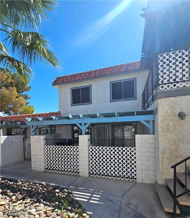 1128 Willow Tree Dr Unit C, Las Vegas, NV 89128 - rear view of property featuring stucco siding and a patio area