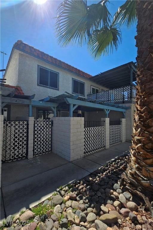 1128 Willow Tree Dr Unit C, Las Vegas, NV 89128 - back of property featuring stucco siding and a patio