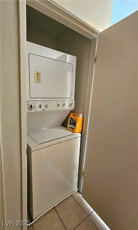 1128 Willow Tree Dr Unit C, Las Vegas, NV 89128 - washroom with estacked washer and dryer and tile patterned floors