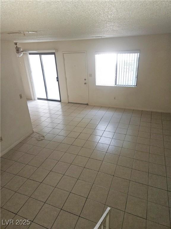 1128 Willow Tree Dr Unit C, Las Vegas, NV 89128 - unfurnished room featuring a textured ceiling and light tile patterned floors