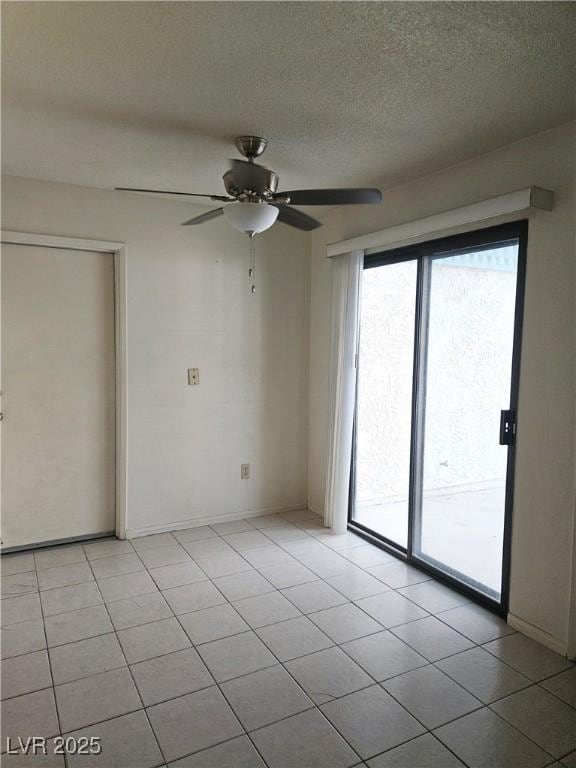 1128 Willow Tree Dr Unit C, Las Vegas, NV 89128 - empty room with a ceiling fan, a textured ceiling, and light tile patterned floors