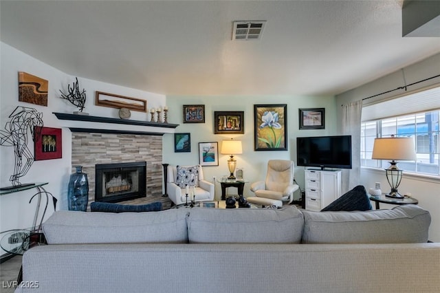 living area with a tile fireplace