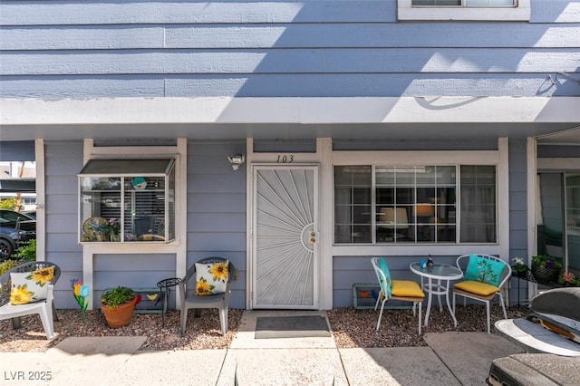 view of exterior entry featuring a porch