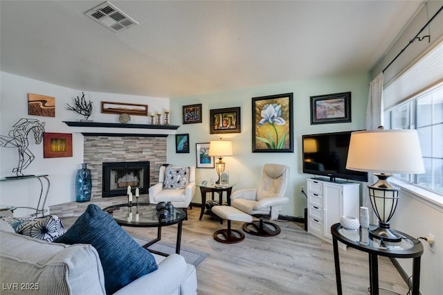 living room featuring a fireplace and wood finished floors