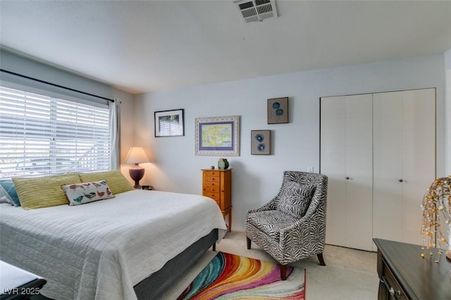 bedroom featuring light carpet and a closet