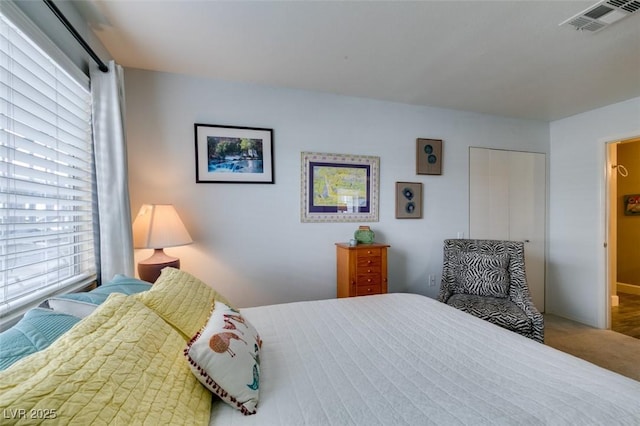 carpeted bedroom with multiple windows