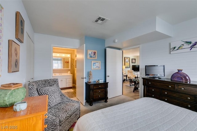 carpeted bedroom with ensuite bath