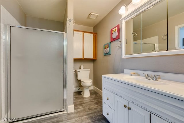 full bath with a stall shower, toilet, and wood finished floors
