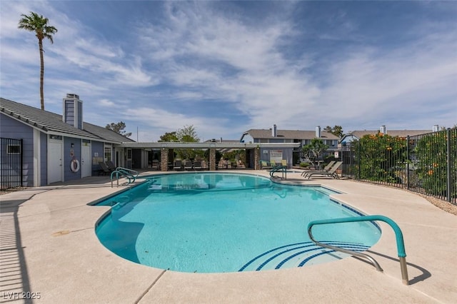 community pool with fence and a patio area