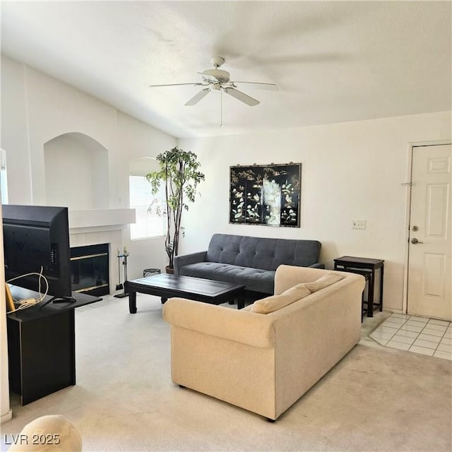 5415 W Harmon Ave Unit 2094, Las Vegas, NV 89103 - living room featuring a ceiling fan, light carpet, a fireplace, and light tile patterned floors