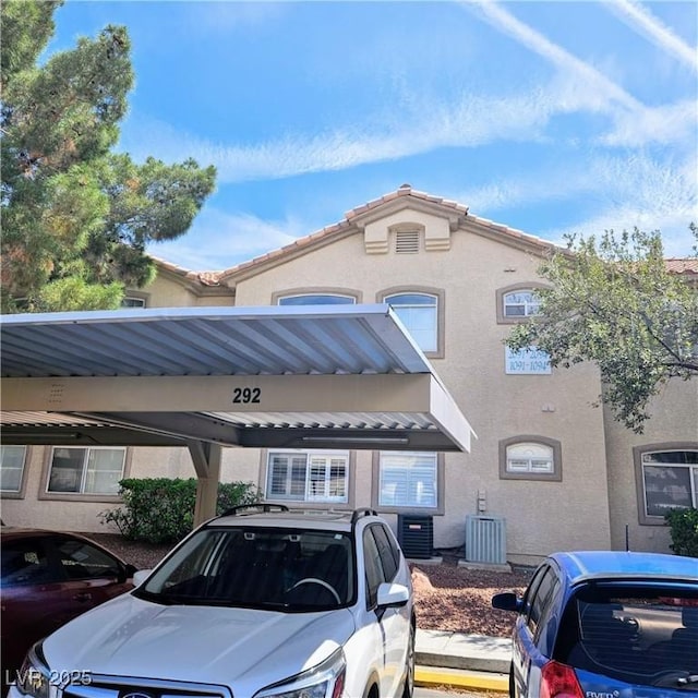 5415 W Harmon Ave Unit 2094, Las Vegas, NV 89103 - view of building exterior featuring covered parking and central AC