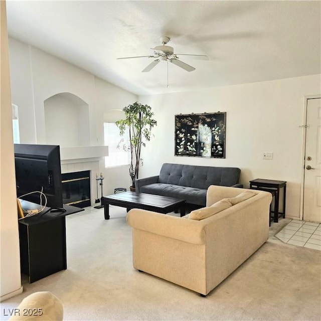 5415 W Harmon Ave Unit 2094, Las Vegas, NV 89103 - living room with light colored carpet, ceiling fan, and a tiled fireplace
