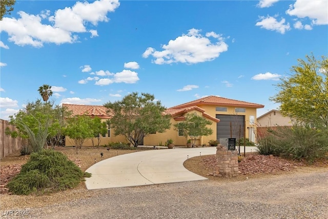 4185 W Arby Ave, Las Vegas, NV 89118 - view of front of house featuring curved driveway, fence, stucco siding, a tiled roof, and a garage