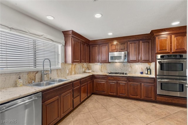 4185 W Arby Ave, Las Vegas, NV 89118 - kitchen with appliances with stainless steel finishes, a sink, light tile patterned flooring, decorative backsplash, and recessed lighting