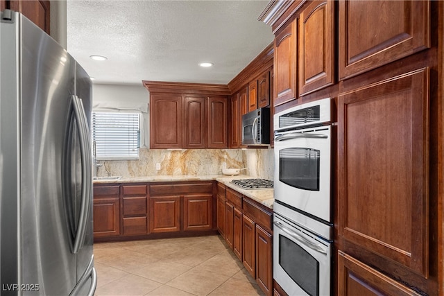 4185 W Arby Ave, Las Vegas, NV 89118 - kitchen featuring stainless steel appliances, backsplash, light tile patterned floors, light stone countertops, and recessed lighting