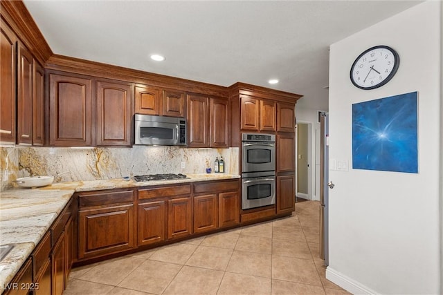 4185 W Arby Ave, Las Vegas, NV 89118 - kitchen featuring appliances with stainless steel finishes, light tile patterned flooring, backsplash, baseboards, and recessed lighting