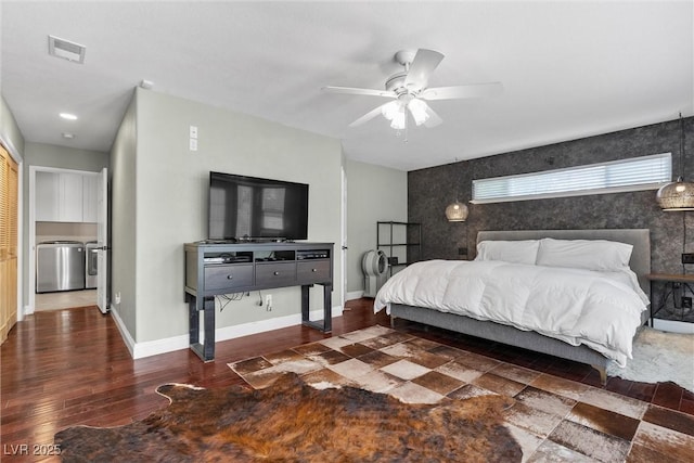 4185 W Arby Ave, Las Vegas, NV 89118 - bedroom featuring an accent wall, baseboards, washing machine and clothes dryer, wood finished floors, and a ceiling fan