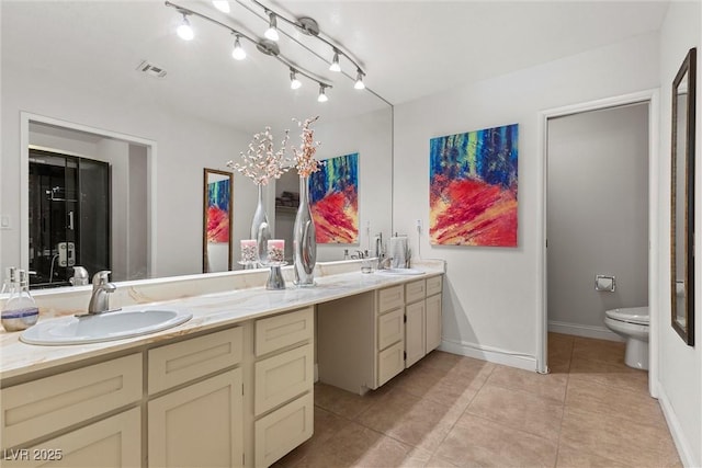 4185 W Arby Ave, Las Vegas, NV 89118 - bathroom with double vanity, tile patterned flooring, toilet, and baseboards