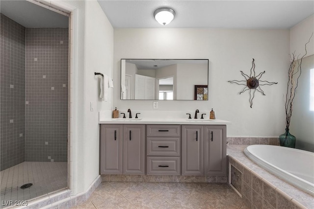4185 W Arby Ave, Las Vegas, NV 89118 - bathroom with tile patterned floors, a garden tub, a shower stall, and double vanity