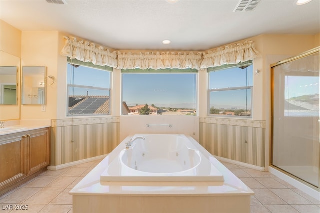 395 Suzanne Peak Ct, Henderson, NV 89012 - full bathroom with a whirlpool tub, a shower stall, vanity, wainscoting, and tile patterned flooring