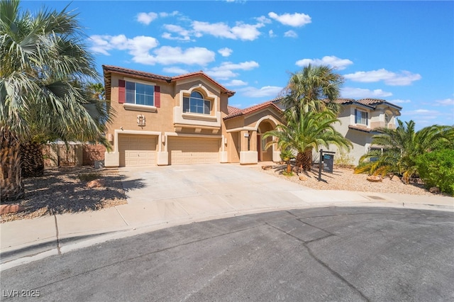 395 Suzanne Peak Ct, Henderson, NV 89012 - mediterranean / spanish-style house with an attached garage, stucco siding, concrete driveway, and a tiled roof