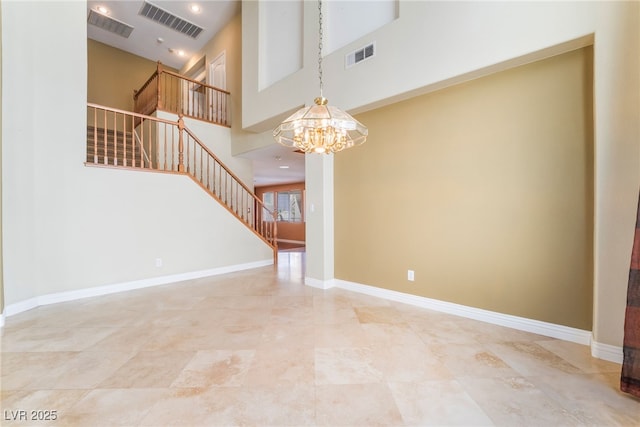 395 Suzanne Peak Ct, Henderson, NV 89012 - unfurnished living room featuring stairway, a chandelier, and a towering ceiling