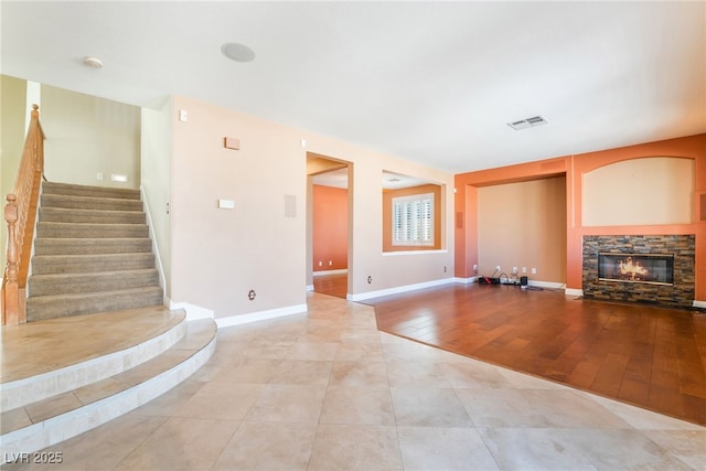 395 Suzanne Peak Ct, Henderson, NV 89012 - unfurnished living room featuring a fireplace, stairway, and light tile patterned floors