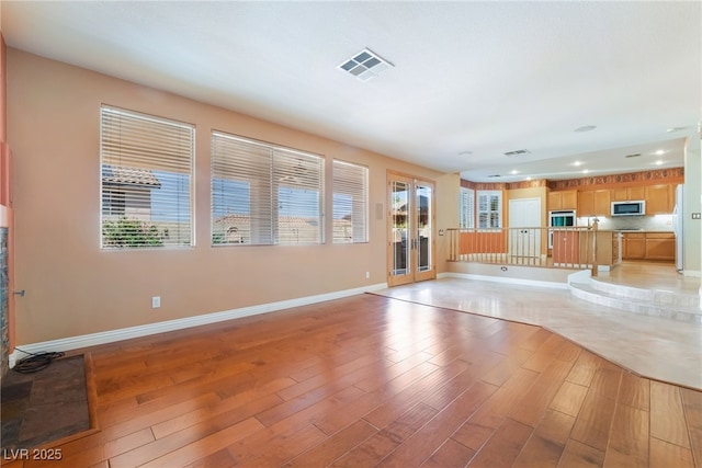 395 Suzanne Peak Ct, Henderson, NV 89012 - unfurnished living room with light wood-style floors and recessed lighting