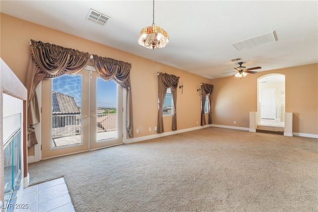 395 Suzanne Peak Ct, Henderson, NV 89012 - unfurnished living room featuring carpet floors, arched walkways, and a ceiling fan