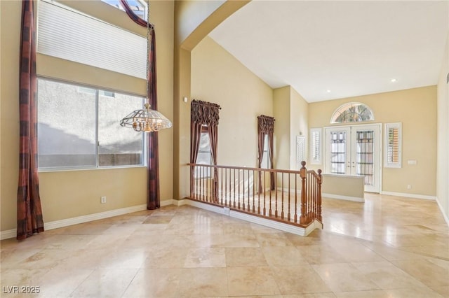 395 Suzanne Peak Ct, Henderson, NV 89012 - tiled empty room with french doors, arched walkways, and a high ceiling