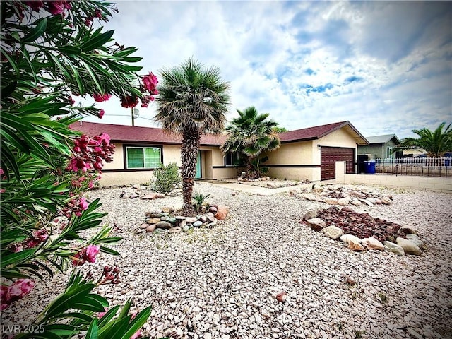 4881 E Imperial Ave, Las Vegas, NV 89104 - ranch-style home with an attached garage, stucco siding, fence, and driveway