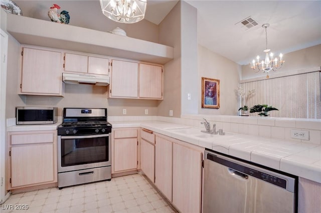 5000 Red Rock St Unit 237, Las Vegas, NV 89118 - kitchen with a chandelier, stainless steel appliances, under cabinet range hood, a sink, and light floors