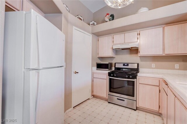 5000 Red Rock St Unit 237, Las Vegas, NV 89118 - kitchen with appliances with stainless steel finishes, light floors, under cabinet range hood, tile countertops, and light brown cabinetry