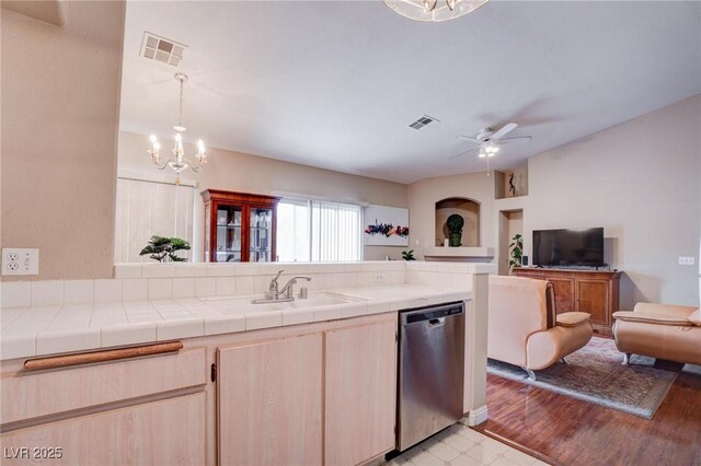 5000 Red Rock St Unit 237, Las Vegas, NV 89118 - kitchen with stainless steel dishwasher, open floor plan, a chandelier, a peninsula, and tile countertops