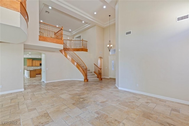 10761 Capesthorne Way, Las Vegas, NV 89135 - unfurnished living room with arched walkways, a towering ceiling, stone tile floors, baseboards, and ornamental molding