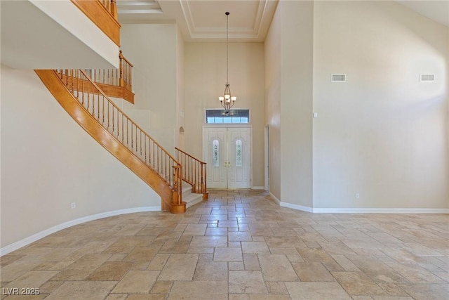 10761 Capesthorne Way, Las Vegas, NV 89135 - foyer featuring a towering ceiling, stone tile floors, stairway, a chandelier, and baseboards