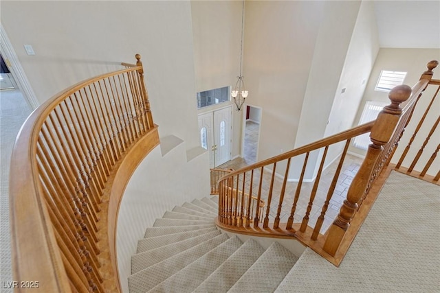10761 Capesthorne Way, Las Vegas, NV 89135 - stairway with carpet flooring, a chandelier, and baseboards