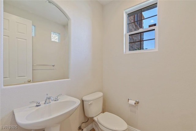 10761 Capesthorne Way, Las Vegas, NV 89135 - half bath with a sink, toilet, healthy amount of natural light, and baseboards