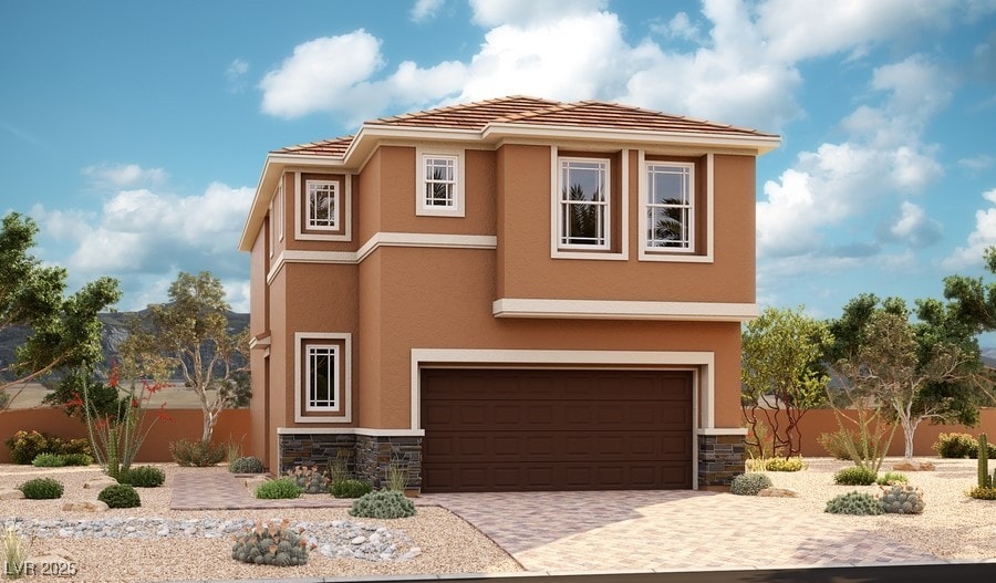 1050 Ferodale Ave, North Las Vegas, NV 89084 - view of front of house featuring stucco siding, stone siding, a garage, and driveway