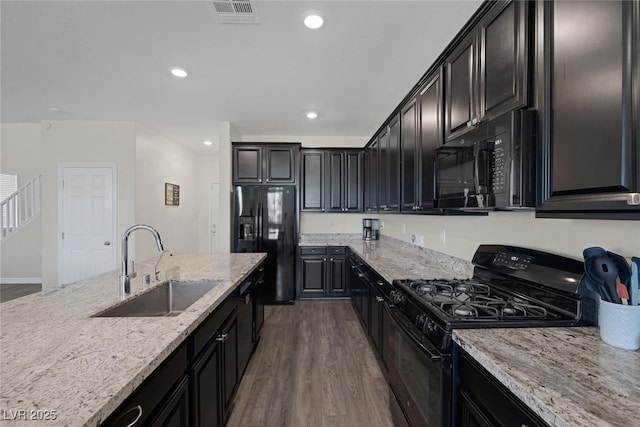 4050 Midnight Crest Ave, North Las Vegas, NV 89031 - kitchen with black appliances, a sink, dark wood-style floors, recessed lighting, and light stone counters
