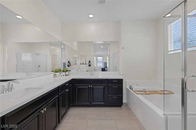 4050 Midnight Crest Ave, North Las Vegas, NV 89031 - bathroom featuring a stall shower, a garden tub, double vanity, and tile patterned flooring
