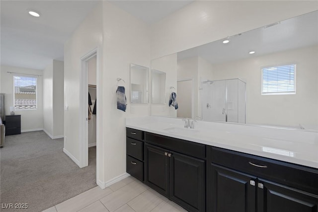 4050 Midnight Crest Ave, North Las Vegas, NV 89031 - bathroom with vanity, a walk in closet, baseboards, and recessed lighting