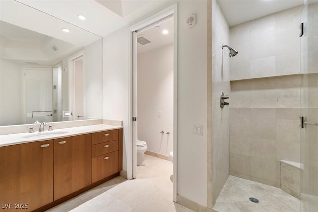 full bath with a shower stall, toilet, vanity, and recessed lighting