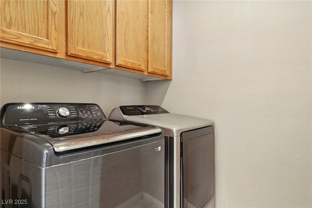 5380 Flowing Spring St, Las Vegas, NV 89122 - laundry room featuring cabinet space and washing machine and clothes dryer