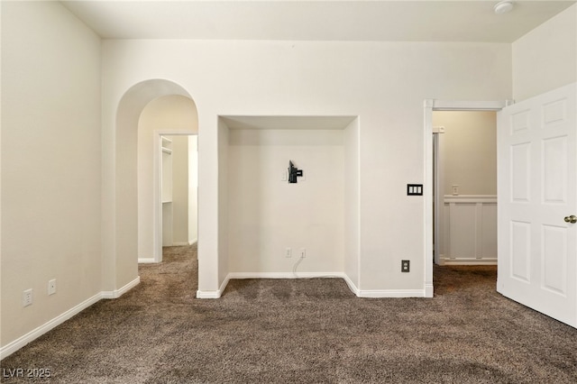 5380 Flowing Spring St, Las Vegas, NV 89122 - spare room featuring dark carpet and arched walkways