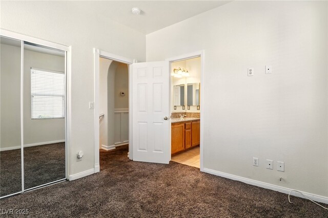 5380 Flowing Spring St, Las Vegas, NV 89122 - unfurnished bedroom with arched walkways, carpet flooring, a closet, and ensuite bathroom