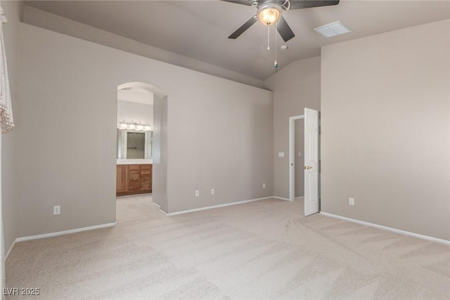 8266 Lincoln Valley St, Las Vegas, NV 89123 - unfurnished bedroom with light carpet, arched walkways, ensuite bath, baseboards, and vaulted ceiling