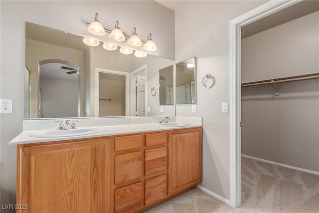 8266 Lincoln Valley St, Las Vegas, NV 89123 - bathroom with double vanity, a walk in closet, and baseboards