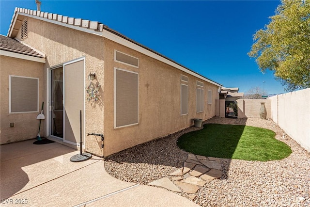 8266 Lincoln Valley St, Las Vegas, NV 89123 - view of side of property with a fenced backyard, stucco siding, and a patio